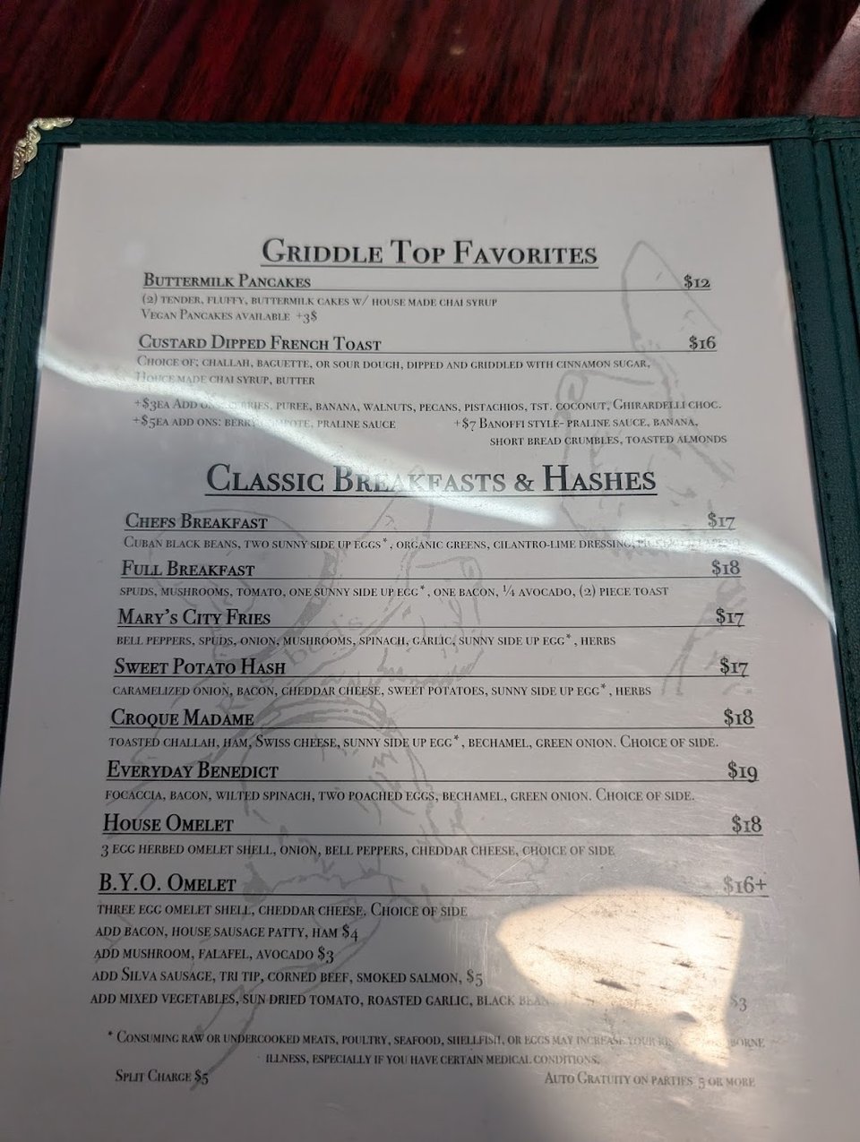 Simple printed menu beside a coffee cup